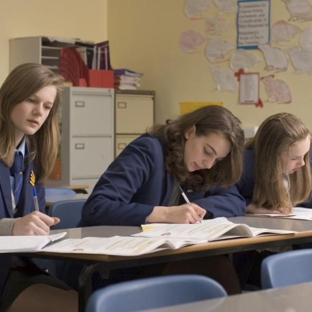 Teenagers studying in a classroom.