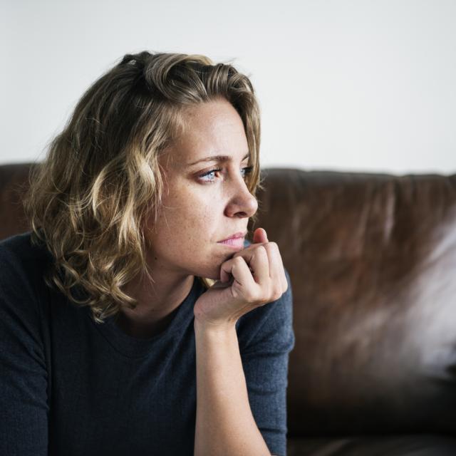 Woman resting head in hands