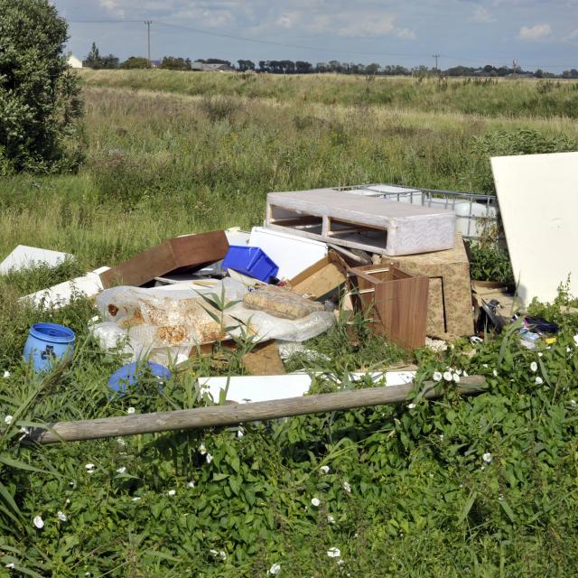 Abandoned rubbish in green field
