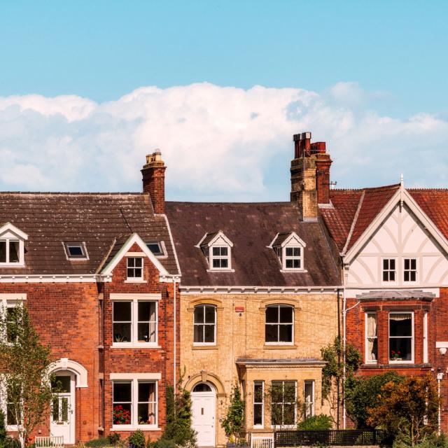 A shot of old brick houses in a row on a sunny day in England