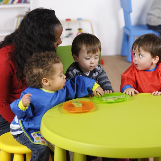 Carer and toddlers learning about nutrition