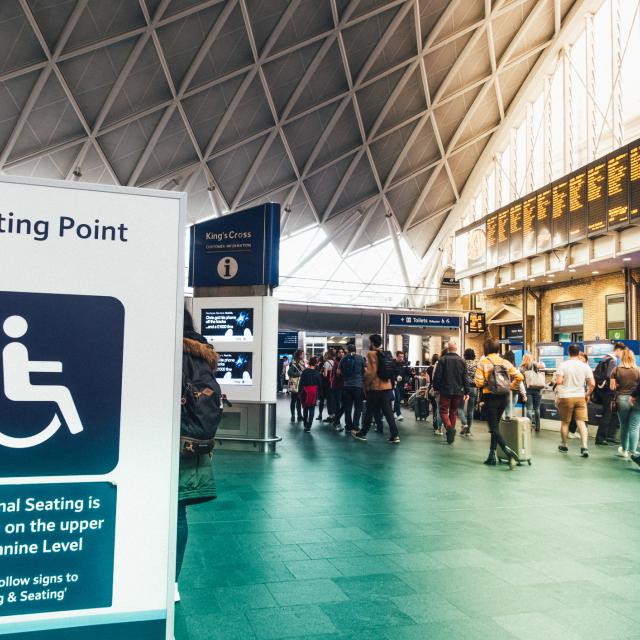 King's Cross meeting point and customer information point board service additional seat and data for passengers in King's Cross train station in rush hour at London, UK.