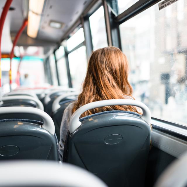 Woman sitting on a bus in London looking out window.