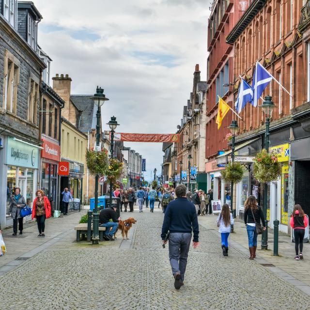 Fort William, Scotland, United Kingdom - September 23, 2017. The High Street in Fort William, Scotland. View with people, historic buildings and commercial properties.