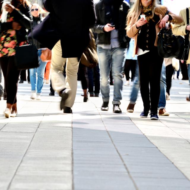 Pedestrians on tiled pavement with long exposure
