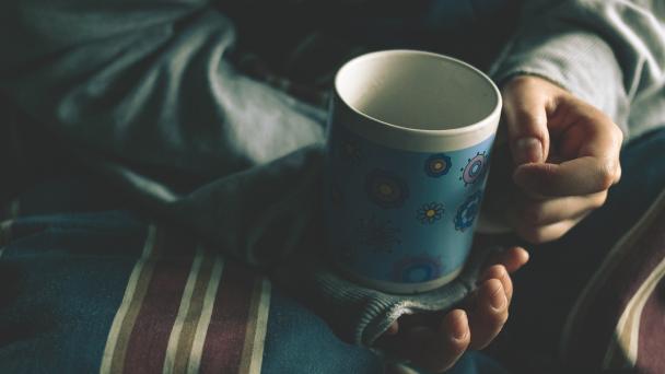 Image of a person's hands holding a coffee cup