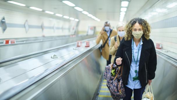 Nurse wearing mask on escalator
