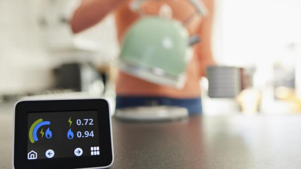 Smart meter in foreground with person in the background