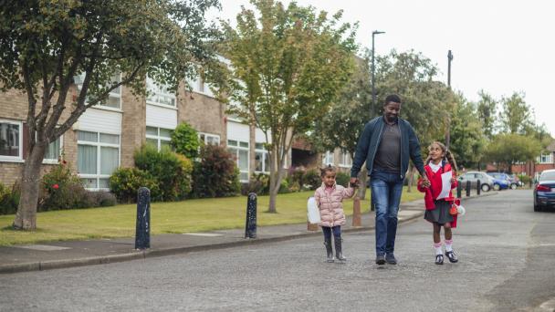 Father and daughters walking in LTN