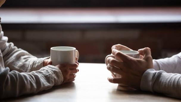 Hands holding coffee cup