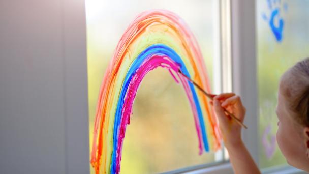 Rainbow on window in of support NHS