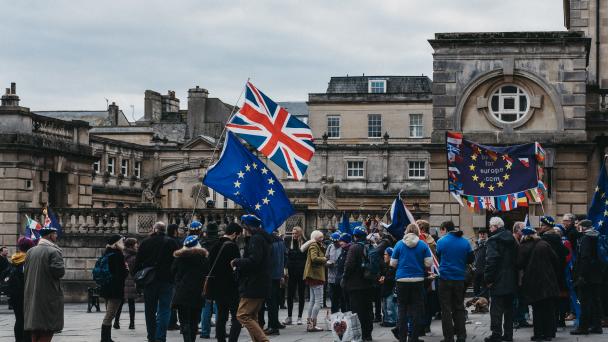 Crowd of people protesting with EU/UK flags