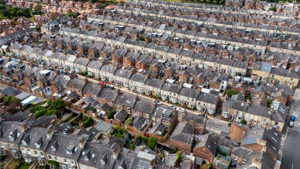 Aerial view of old terraced houses on back to back streets in the suburbs of a large UK city