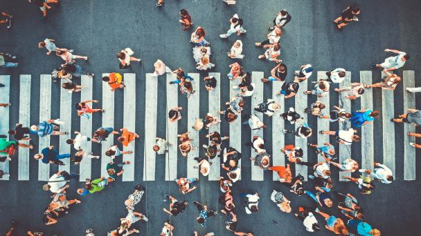 Aerial photo of people crossing a zebra crossing.