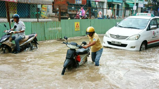 Ho Chi Minh city, VietNam - October 2, 2014: Motorists struggle in flooded streets