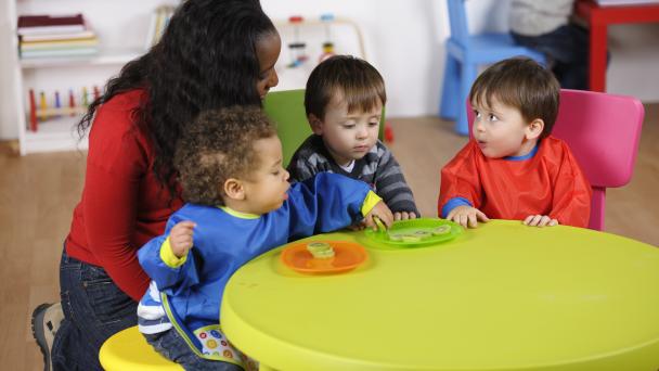 Carer and toddlers learning about nutrition