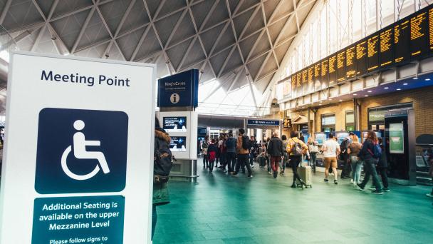 King's Cross meeting point and customer information point board service additional seat and data for passengers in King's Cross train station in rush hour at London, UK.