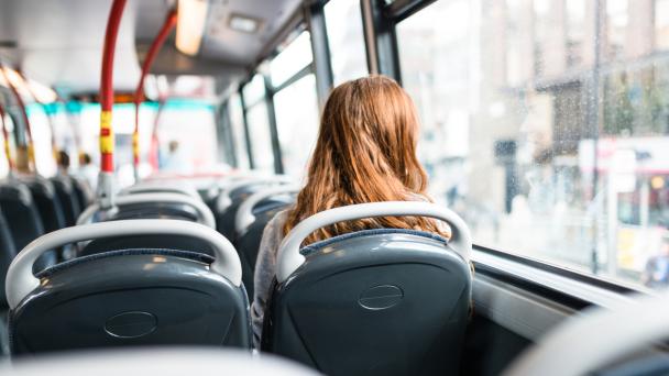 Woman sitting on a bus in London looking out window.
