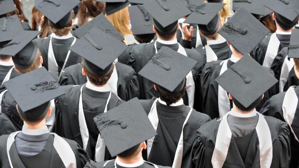 Birmingham, UK: Graduate college students photographed from above wearing traditional mortar board hats and robes at their degree ceremony
