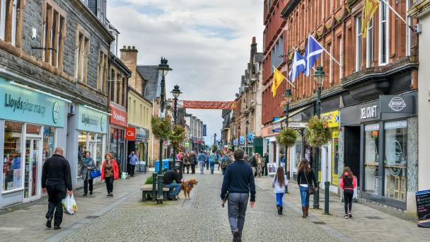 Fort William, Scotland, United Kingdom - September 23, 2017. The High Street in Fort William, Scotland. View with people, historic buildings and commercial properties.