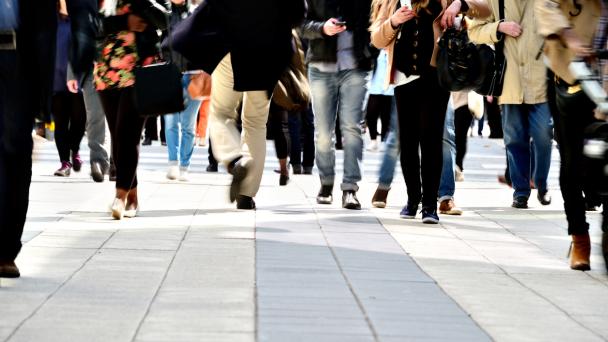Pedestrians on tiled pavement with long exposure