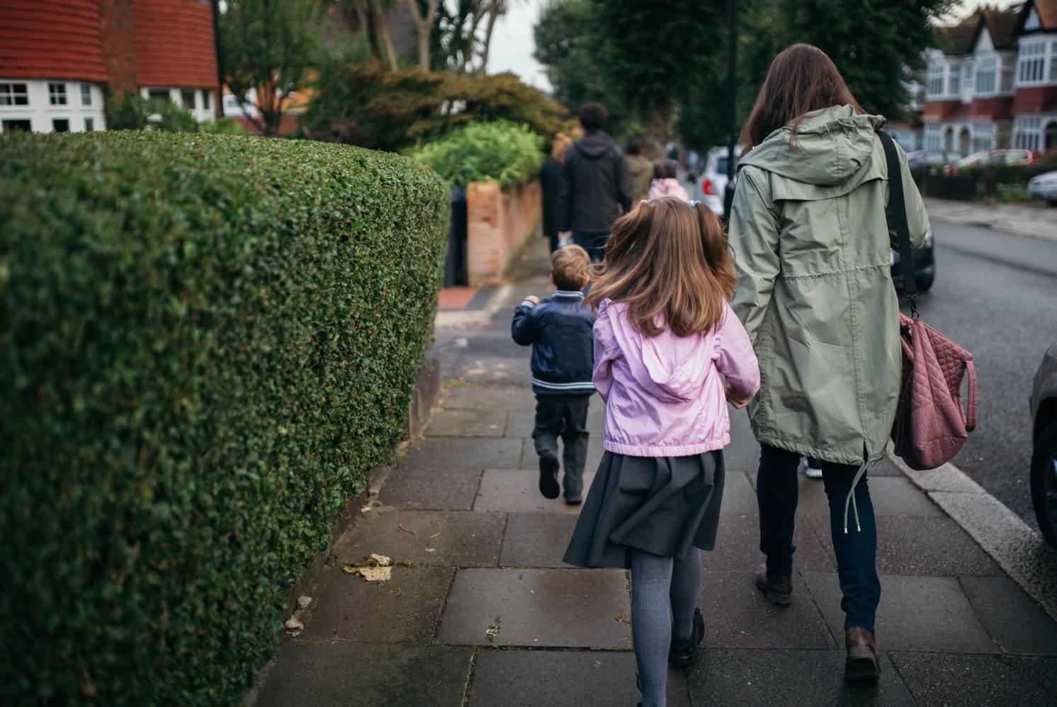 Child walking to school with parent